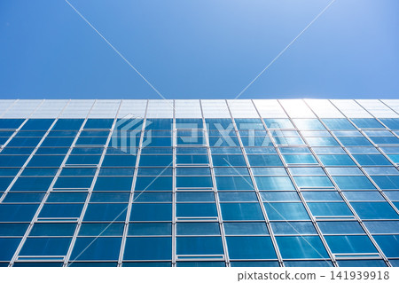 Glass Facade Office Building Under Blue Sky for Modern Architecture Corporate Vision and Real Estate Investment Background, Low Angle Perspective Photo with Copyspace Glass Facade Office Building Under Blue Sky for Modern Architecture Corporate Vision and Real Estate Investment Background, Low Angle Perspective Photo with Copyspace 141939918