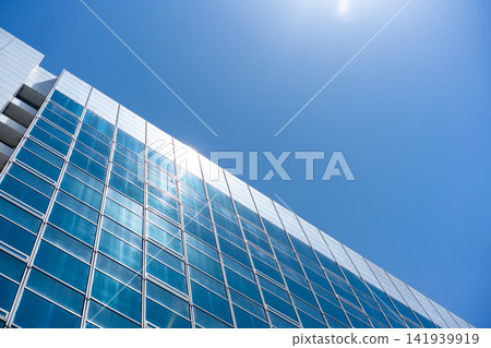 Glass Facade Office Building Under Blue Sky for Modern Architecture Corporate Vision and Real Estate Investment Background, Low Angle Perspective Photo with Copyspace Glass Facade Office Building Under Blue Sky for Modern Architecture Corporate Vision and Real Estate Investment Background, Low Angle Perspective Photo with Copyspace 141939919