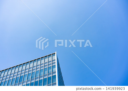 Glass Facade Office Building Corner Under Blue Sky for Modern Architecture Corporate Growth and Real Estate Investment Background, Low Angle Perspective Photo with Copyspace Glass Facade Office Building Corner Under Blue Sky for Modern Architecture Corporate Growth and Real Estate Investment Background, Low Angle Perspective Photo with Copyspace 141939923