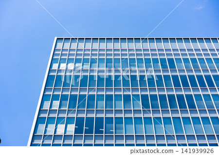 Glass Facade Office Building Corner Under Blue Sky for Modern Architecture Corporate Growth and Real Estate Investment Background, Low Angle Perspective Photo with Copyspace Glass Facade Office Building Corner Under Blue Sky for Modern Architecture Corporate Growth and Real Estate Investment Background, Low Angle Perspective Photo with Copyspace 141939926