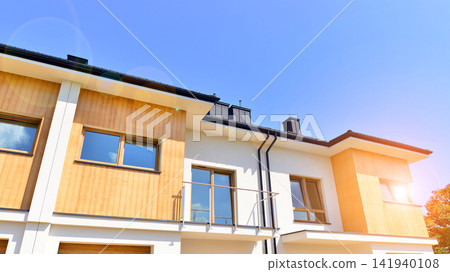 New single family houses in a new development area. Residential homes with modern facade. The real estate market in the suburbs. Terraced family homes in newly developed housing estate. New single family houses in a new development area. Residential homes with modern facade. The real estate market in the suburbs. Terraced family homes in newly developed housing estate. 141940108