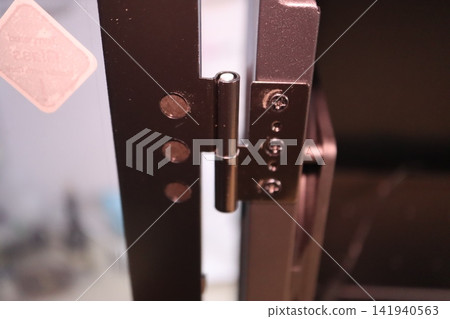 Close-up of Metal Door Hinge Mechanism Close-up of Metal Door Hinge Mechanism 141940563