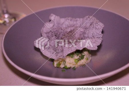 Crispy Rice Dish with Green Garnish on Plate Crispy Rice Dish with Green Garnish on Plate 141940671