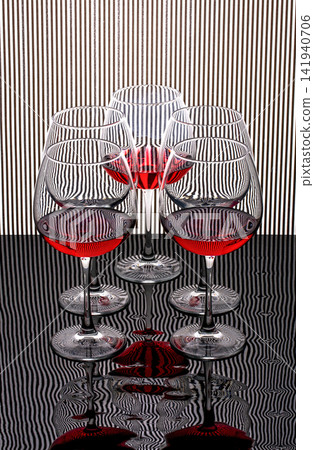 Wine glasses on a background of black and white stripes Wine glasses on a background of black and white stripes 141940706
