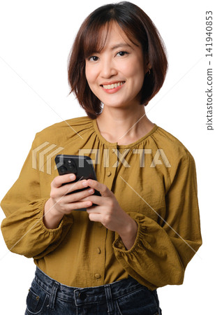 Asian woman smiling while holding smartphone in mustard blouse against transparent background for communication and lifestyle concept Asian woman smiling while holding smartphone in mustard blouse against transparent background for communication and lifestyle concept 141940853