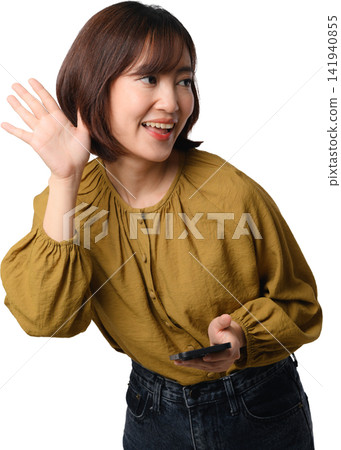 Asian woman waving while holding smartphone with cheerful expression and isolated transparent background 141940855