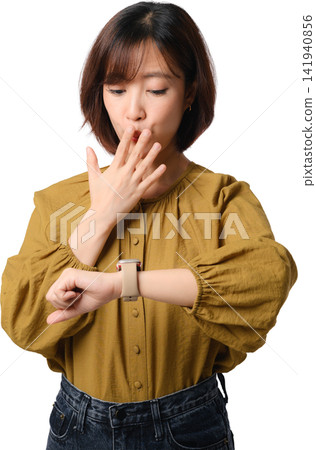 Asian woman checking smartwatch while covering mouth with hand, expressing surprise or concern against transparent background Asian woman checking smartwatch while covering mouth with hand, expressing surprise or concern against transparent background 141940856