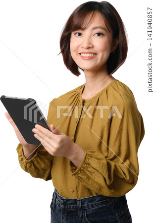 Asian woman holding tablet with friendly smile isolated on transparent background 141940857