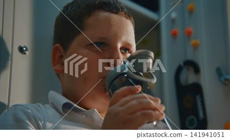 Young Student Relaxing Beside Metal Locker with Homemade Lunch During Recess Young Student Relaxing Beside Metal Locker with Homemade Lunch During Recess 141941051