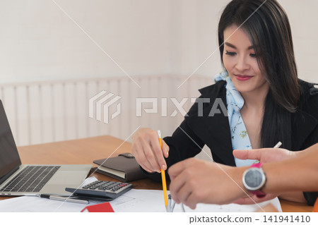 Group of two coworkers working with blueprint in office. co-working teamwork concept. Group of two coworkers working with blueprint in office. co-working teamwork concept. 141941410