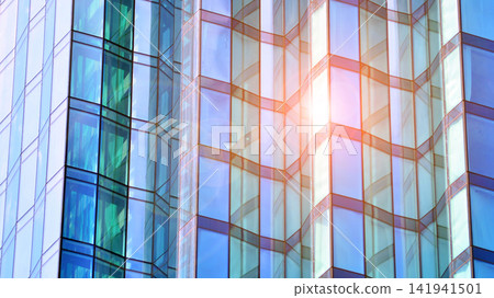 A modern tall building made of steel and glass, housing offices and financial institutions. Glass wall on the facade of the building. A modern tall building made of steel and glass, housing offices and financial institutions. Glass wall on the facade of the building. 141941501