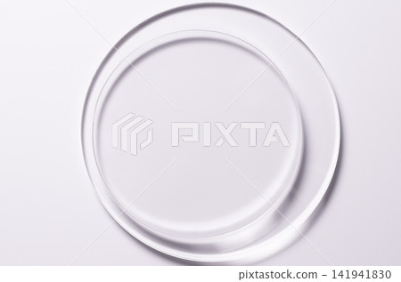 Glass circles on a pink background. A template for placing samples of cosmetics or medical products or food. Glass circles on a pink background. A template for placing samples of cosmetics or medical products or food. 141941830