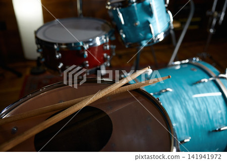 Vintage studio with percussion instruments. Intimate scene of drum in warm lighting Vintage studio with percussion instruments. Intimate scene of drum in warm lighting 141941972