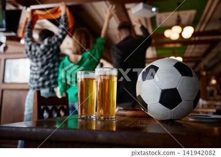 Festive setting with drinks and ball. Ready for match with drinks and lively environment Festive setting with drinks and ball. Ready for match with drinks and lively environment 141942082