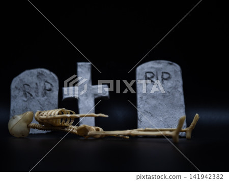 Skeleton in Halloween cemetery black background Skeleton in Halloween cemetery black background 141942382