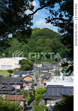 A view of a rural townscape from a shrine on a hill. A view of a rural townscape from a shrine on a hill. 141942689