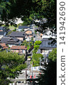 A view of a rural townscape from a shrine on a hill. 141942690