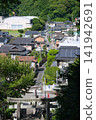 A rural landscape viewed from a shrine on a hill. 141942691