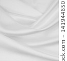 Smooth elegant white silk or satin luxury cloth texture as wedding background. Luxurious background design 141944650