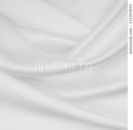 Smooth elegant white silk or satin luxury cloth texture as wedding background. Luxurious background design Smooth elegant white silk or satin luxury cloth texture as wedding background. Luxurious background design 141944650