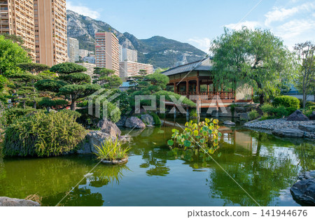 Japanese garden in Monaco and water plants and amazing topiary pine trees and japanese pavilion Japanese garden in Monaco and water plants and amazing topiary pine trees and japanese pavilion 141944676