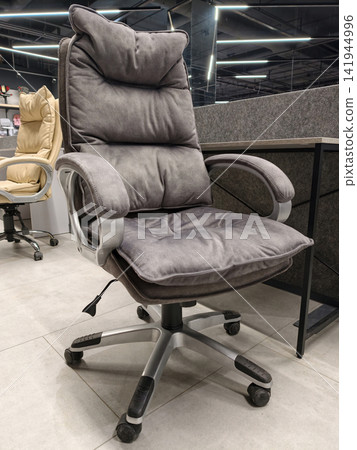 Adjustable grey fabric office chair with height settings for comfort, available in a large shopping mall Adjustable grey fabric office chair with height settings for comfort, available in a large shopping mall 141944996