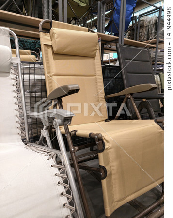 Folding chairs for fishing and tourism showcased in hypermarket environment highlight practical portable seating durable frame and convenient folding mechanism for travel and outdoor use Folding chairs for fishing and tourism showcased in hypermarket environment highlight practical portable seating durable frame and convenient folding mechanism for travel and outdoor use 141944998