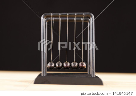 Newton cradle balance balls on the table Newton cradle balance balls on the table 141945147