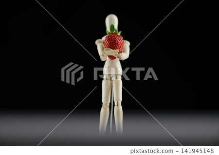 wooden human model and red strawberry wooden human model and red strawberry 141945148