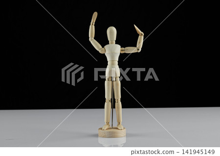 wooden human model poses on the table wooden human model poses on the table 141945149