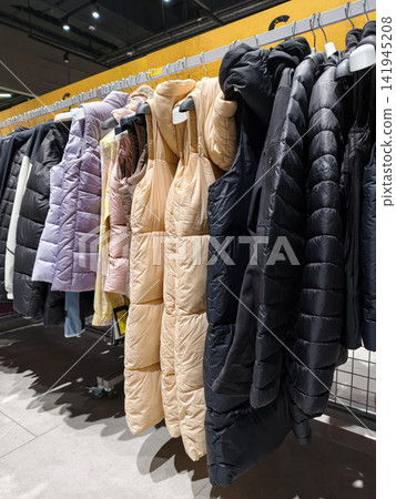 Sleeveless jackets displayed in a retail environment designed for active lifestyle shopping and seasonal fashion Sleeveless jackets displayed in a retail environment designed for active lifestyle shopping and seasonal fashion 141945208