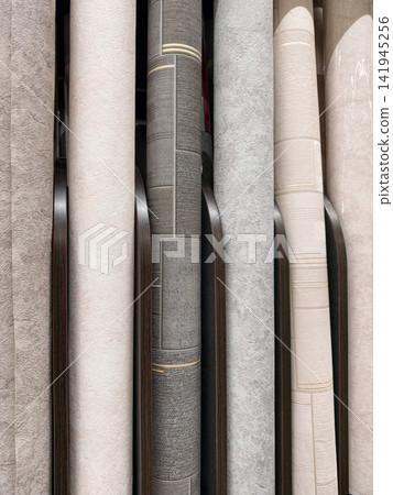 A wide assortment of wallpaper rolls neatly arranged on shelves, featuring vibrant colors and diverse patterns, perfect for home renovations A wide assortment of wallpaper rolls neatly arranged on shelves, featuring vibrant colors and diverse patterns, perfect for home renovations 141945256