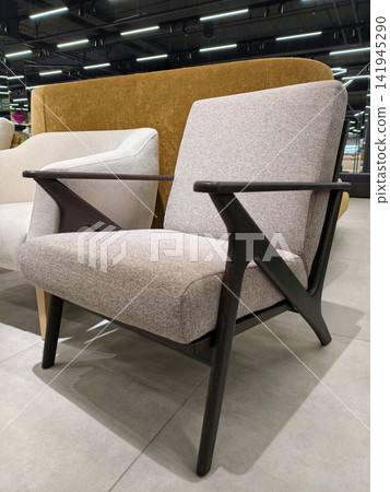 Comfy armchair with wooden armrests for relaxation in the home shop Comfy armchair with wooden armrests for relaxation in the home shop 141945290