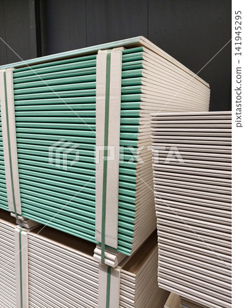 A building materials warehouse storing drywall sheets for construction needs A building materials warehouse storing drywall sheets for construction needs 141945295