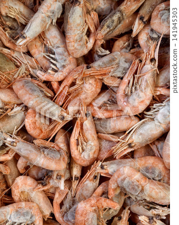 Fresh frozen red prawns displayed in supermarket freezer Fresh frozen red prawns displayed in supermarket freezer 141945303