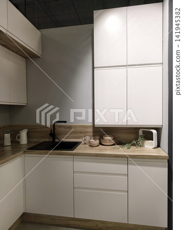 Modern kitchen furniture samples displayed for customer inspection at a hypermarket Modern kitchen furniture samples displayed for customer inspection at a hypermarket 141945382