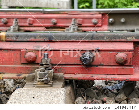 Rail pad secured with red fastener prevents metal contact and ensures safety Rail pad secured with red fastener prevents metal contact and ensures safety 141945417