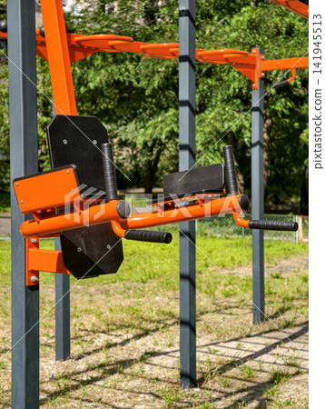 Outdoor fitness complex with metal exercise structures in a residential area for strength training, workout activities and healthy lifestyle Outdoor fitness complex with metal exercise structures in a residential area for strength training, workout activities and healthy lifestyle 141945513