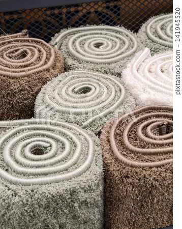 Carpet rolls presented in close up featuring carefully woven fibers and stylish designs Carpet rolls presented in close up featuring carefully woven fibers and stylish designs 141945520