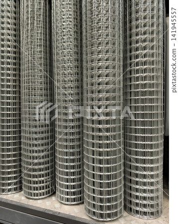 Galvanized welded mesh coils displayed in a supermarket aisle dedicated to construction and fencing materials Galvanized welded mesh coils displayed in a supermarket aisle dedicated to construction and fencing materials 141945557