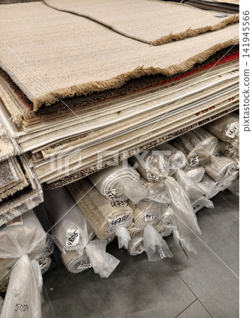 Carpets showcased on organized shelves with rolled floor coverings wrapped for protection underneath Carpets showcased on organized shelves with rolled floor coverings wrapped for protection underneath 141945566