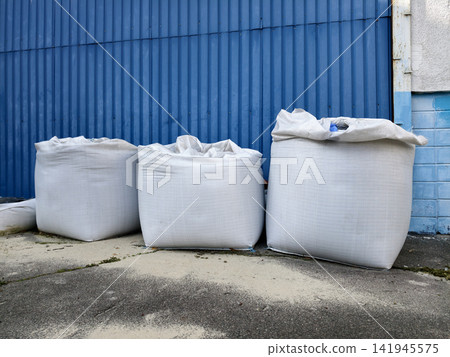 Sandbags positioned by the warehouse gates as a measure against potential hazards Sandbags positioned by the warehouse gates as a measure against potential hazards 141945575