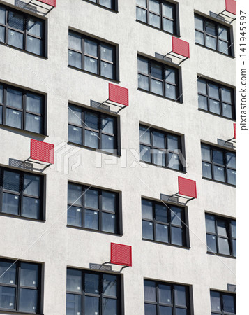 Residential complex featuring red outdoor air conditioner brackets Residential complex featuring red outdoor air conditioner brackets 141945597