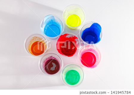 colored paints dried in plastic cups colored paints dried in plastic cups 141945784
