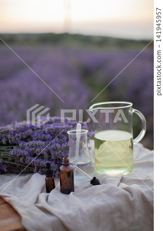 Amber essential lavender oil bottle. Violet lavendar field in Provence. Amber essential lavender oil bottle. Violet lavendar field in Provence. 141945957