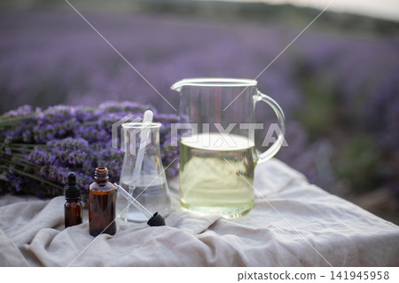 Amber essential lavender oil bottle. Violet lavendar field in Provence. Amber essential lavender oil bottle. Violet lavendar field in Provence. 141945958