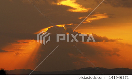 Solar Eclipse, Red Sky and Dramatic Clouds at Sunset Solar Eclipse, Red Sky and Dramatic Clouds at Sunset 141946371