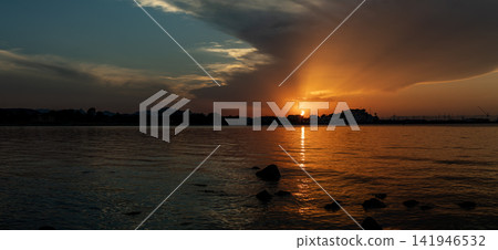 Panoramic view of a deep partial solar eclipse over Denia Spain showing golden light beam across the sea Panoramic view of a deep partial solar eclipse over Denia Spain showing golden light beam across the sea 141946532