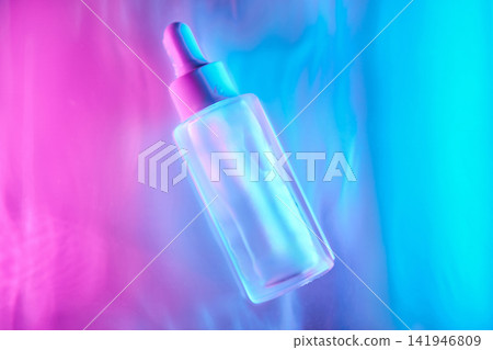 Cosmetic serum dropper bottle glowing with neon light Cosmetic serum dropper bottle glowing with neon light 141946809