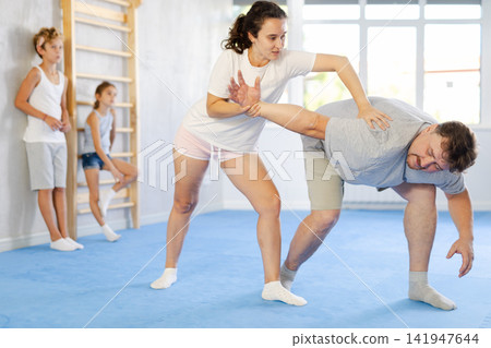 Man and woman training self-defense techniques Man and woman training self-defense techniques 141947644
